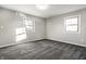 This bedroom features neutral walls, gray carpet, and dual windows providing ample natural light at 8510 E Mcgregor Rd, Indianapolis, IN 46259