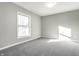 This bedroom features neutral walls, gray carpet, and a window providing ample natural light at 8510 E Mcgregor Rd, Indianapolis, IN 46259