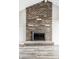 Close up of a brick fireplace with black inset; with gray mantle and hearth at 8510 E Mcgregor Rd, Indianapolis, IN 46259