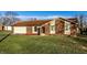 Charming brick home featuring an attached garage and well-maintained front lawn at 8510 E Mcgregor Rd, Indianapolis, IN 46259