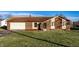 Charming brick home featuring an attached garage and well-maintained front lawn at 8510 E Mcgregor Rd, Indianapolis, IN 46259
