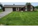 Charming brick home with a well-maintained lawn and attached two car garage at 8510 E Mcgregor Rd, Indianapolis, IN 46259