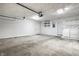 Bright garage with concrete floors, white walls and trim, and plenty of space for storage and other possibilities at 8510 E Mcgregor Rd, Indianapolis, IN 46259