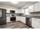 Bright kitchen featuring white cabinets, stainless steel appliances, and granite countertops at 8510 E Mcgregor Rd, Indianapolis, IN 46259
