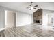 Open living room with vaulted ceilings, a brick fireplace, and views to the kitchen at 8510 E Mcgregor Rd, Indianapolis, IN 46259