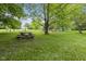 Inviting backyard picnic area for outdoor dining surrounded by lush greenery and mature trees at 8513 S 575 W, Morgantown, IN 46160