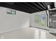 Basement featuring a painted floor and double doors that lead to the outdoor yard at 8513 S 575 W, Morgantown, IN 46160