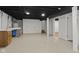 Finished basement area with painted ceiling, utility sink, and access to additional rooms at 8513 S 575 W, Morgantown, IN 46160