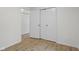 Neutral hallway with laminate floors and multiple access doors at 8513 S 575 W, Morgantown, IN 46160