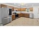 Spacious kitchen features stainless steel appliances, wood cabinetry and wood-look flooring at 8513 S 575 W, Morgantown, IN 46160