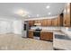 Open kitchen view with stainless steel appliances, wood cabinetry and modern lighting at 8513 S 575 W, Morgantown, IN 46160