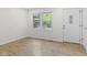 Bright room featuring wood-look flooring, a large window, and a front door at 8513 S 575 W, Morgantown, IN 46160