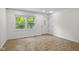 Bright living room featuring wood-look flooring, a large window, and a front door at 8513 S 575 W, Morgantown, IN 46160