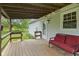 Covered porch with stained wood and outdoor seating perfect for entertaining and relaxing outdoors at 8513 S 575 W, Morgantown, IN 46160