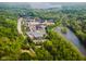 Aerial view of a commercial area and wooded areas with a pond in the background and roadways in the foreground at 9602 Fall Creek Rd, Indianapolis, IN 46256