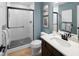 Well-lit bathroom with a walk-in shower featuring black hardware and a modern sink and commode at 9602 Fall Creek Rd, Indianapolis, IN 46256