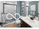 Cozy bathroom with tile flooring, modern vanity, and a shower tub at 9602 Fall Creek Rd, Indianapolis, IN 46256