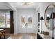 Bright foyer with hardwood floors, statement light fixture, and grand front doors with views at 9602 Fall Creek Rd, Indianapolis, IN 46256