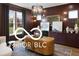 Stylish home office with custom built-ins, warm wood tones, and natural light making it ideal for productivity at 9602 Fall Creek Rd, Indianapolis, IN 46256