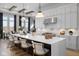 Spacious kitchen with white cabinets, large island, stainless steel appliances, and stylish pendant lights at 9602 Fall Creek Rd, Indianapolis, IN 46256
