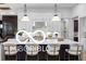 A bright kitchen featuring a large island, pendant lighting, and modern white cabinetry at 9602 Fall Creek Rd, Indianapolis, IN 46256