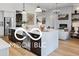 Open kitchen featuring a large island, stainless steel appliances, and ample cabinet space, perfect for modern living at 9602 Fall Creek Rd, Indianapolis, IN 46256