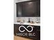 This kitchen features dark wood cabinets, white countertops, and gold hardware accents at 9602 Fall Creek Rd, Indianapolis, IN 46256