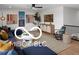 Cozy loft area featuring a comfortable sectional sofa and stylish decor providing an inviting space for relaxation at 9602 Fall Creek Rd, Indianapolis, IN 46256