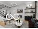 This is a stylish living room featuring a fireplace, open staircase, and contemporary decor at 9602 Fall Creek Rd, Indianapolis, IN 46256