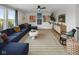 Comfortable living room with plush blue sectional, modern artwork, and inviting atmosphere at 9602 Fall Creek Rd, Indianapolis, IN 46256