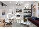 This is a living room with a modern fireplace, mounted television, and stylish decor at 9602 Fall Creek Rd, Indianapolis, IN 46256