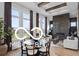 Bright and airy living room with floor-to-ceiling windows, a fireplace, and wooden beams highlighting the ceiling detail at 9602 Fall Creek Rd, Indianapolis, IN 46256