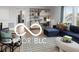 Living room with cozy seating area, built-in shelving, and a stylish workspace at 9602 Fall Creek Rd, Indianapolis, IN 46256