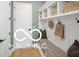 Mudroom featuring built-in storage, a bench, and convenient access to the home at 9602 Fall Creek Rd, Indianapolis, IN 46256