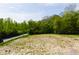 An aerial view showcases the property lot with lush trees surrounding it and a clear blue sky above at 9602 Fall Creek Rd, Indianapolis, IN 46256