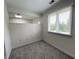 Cozy bedroom with gray carpet, window, and partial wall with arched opening at 9655 Cedar Cove Ln, Indianapolis, IN 46250