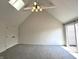 Spacious bedroom boasts vaulted ceilings, skylight, neutral carpeting, and sliding door to deck at 9655 Cedar Cove Ln, Indianapolis, IN 46250