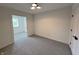 Neutral carpet, window with wood blinds, and an open doorway create an inviting bedroom space at 9655 Cedar Cove Ln, Indianapolis, IN 46250