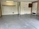 Spacious garage with epoxy flooring, built-in shelving, and ample storage space for vehicles and tools at 9655 Cedar Cove Ln, Indianapolis, IN 46250