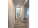 Bright hallway featuring wood floors, white walls, and multiple doorways providing easy access to rooms at 9655 Cedar Cove Ln, Indianapolis, IN 46250