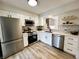 Modern kitchen with stainless steel appliances, white cabinets, and decorative backsplash at 9655 Cedar Cove Ln, Indianapolis, IN 46250