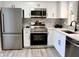Modern kitchen with stainless steel appliances, white cabinetry, and new countertops at 9655 Cedar Cove Ln, Indianapolis, IN 46250
