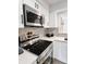 Modern kitchen showcasing a sleek cooktop, stainless steel appliances, and stylish backsplash at 9655 Cedar Cove Ln, Indianapolis, IN 46250