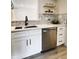 Cozy kitchenette featuring white cabinetry, modern stainless steel appliances, sleek quartz countertops, and floating shelves at 9655 Cedar Cove Ln, Indianapolis, IN 46250