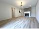 Spacious living room with modern fireplace, white trim, and light hardwood flooring at 9655 Cedar Cove Ln, Indianapolis, IN 46250
