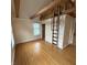 Finished attic with hardwood floors, a loft ladder, and natural light at 989 Woodruff Pl E Dr, Indianapolis, IN 46201