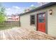 Inviting back porch area with wooden flooring, offering a cozy outdoor space, perfect for relaxing and entertaining at 989 Woodruff Pl E Dr, Indianapolis, IN 46201