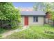 Secluded backyard with a quaint outbuilding, complemented by lush greenery and a stone path at 989 Woodruff Pl E Dr, Indianapolis, IN 46201