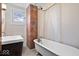 Bathroom featuring exposed brick, a claw foot tub, and updated fixtures at 989 Woodruff Pl E Dr, Indianapolis, IN 46201