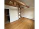 Bedroom boasts wood floors, light walls, and a ladder to a loft above at 989 Woodruff Pl E Dr, Indianapolis, IN 46201